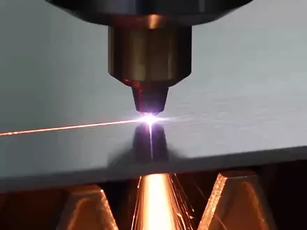 A laser cutting an aluminum panel in the shop